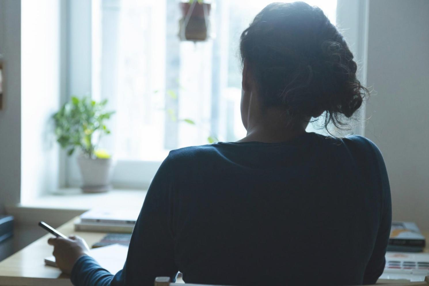 Person reviewing financial documents and budget planning materials